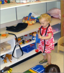 child examining a toy