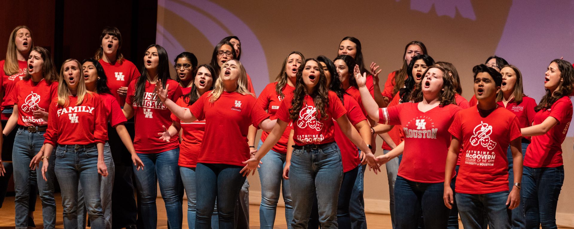 UH Concert Chorale singing in red UH shirts