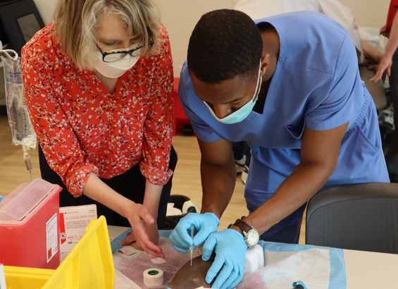 Dr. Horn instructs student in lab