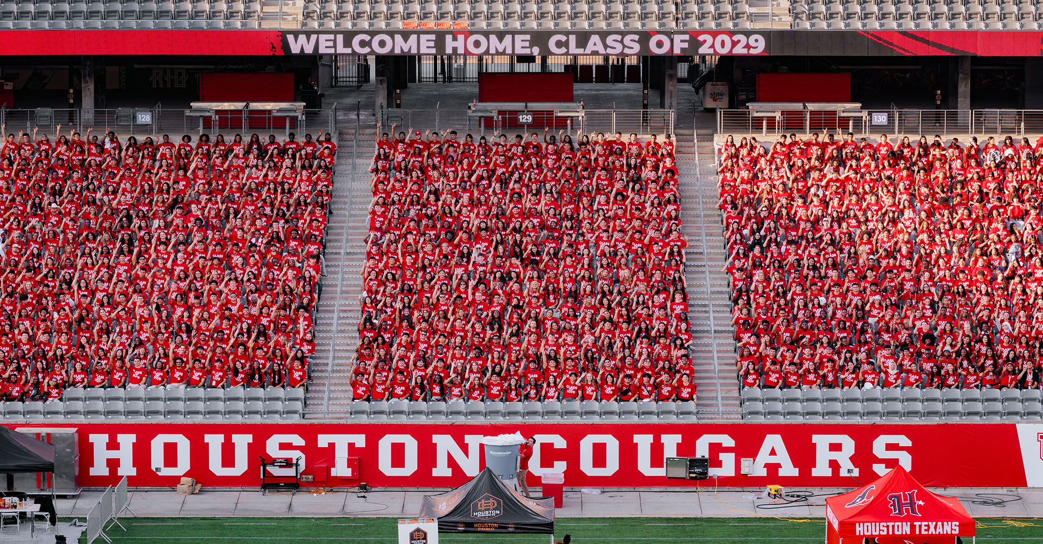 Group photo of hundreds of students making up the University of Houston class of 2029 joined together in the stands of TDECU Stadium.