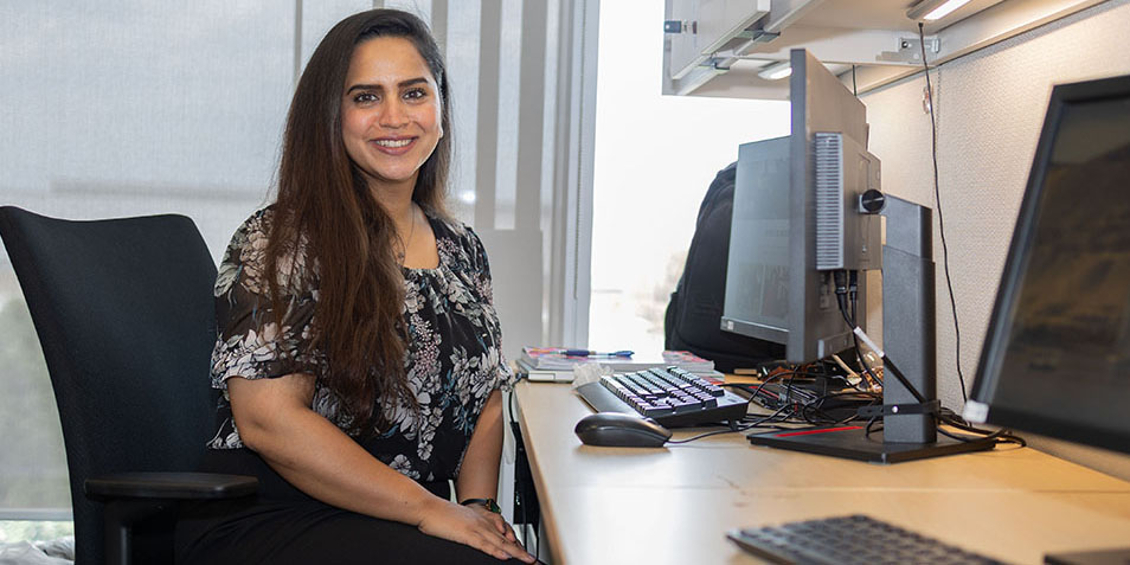 Photo of Bilqees Fatima sitting in a chair and smiling