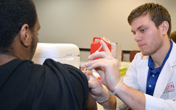 photo of student providing immunization