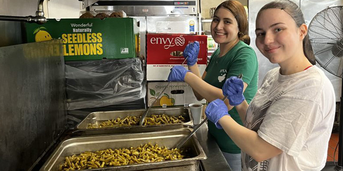 Students volunteer at the food kitchen Loaves and Fishes.