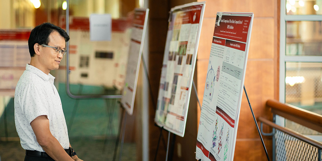 Attendee looking intently at a poster