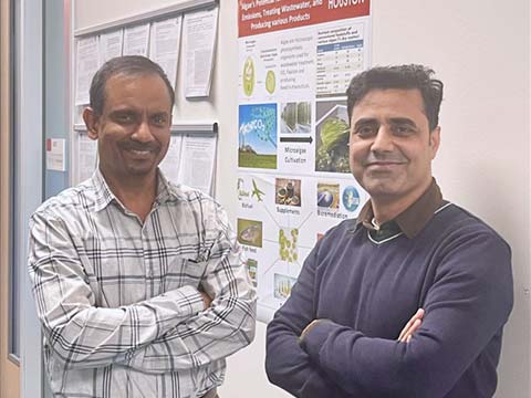 Two scientists, one Indian and another Pakistani, stand together in a hallway.