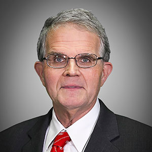 Portrait of a man with silver hair and glasses