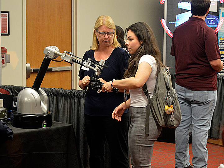 people looking at a robot